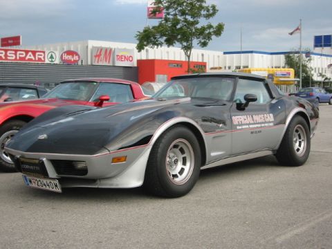 1992 Ford Crown Victoria - A Chevrolet Corvette, identified as an "OFFICIAL PACE CAR", is parked in front of a commercial building.
