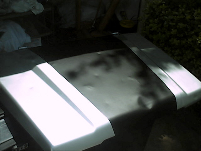 Silver hood with black stripe and dented section
