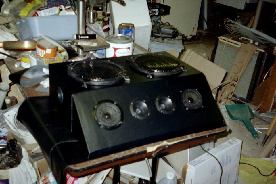 Speaker box with speakers and black vinyl.