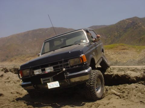 1988 Ford Bronco - This 1988 Ford Bronco navigates a challenging off-road terrain with its front wheels angled.
