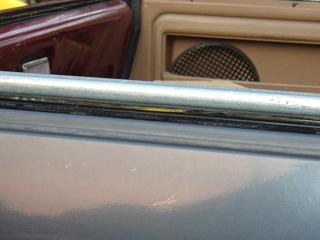 1991 Ford Bronco - Close-up view of a car's interior door panel and speaker.