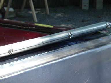 1991 Ford Bronco - Metal trim piece with screws, likely a car part. Supermotors.net logo visible.