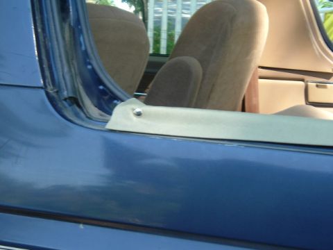 1991 Ford Bronco - Interior view of a blue SUV, focusing on the door frame and seating area.