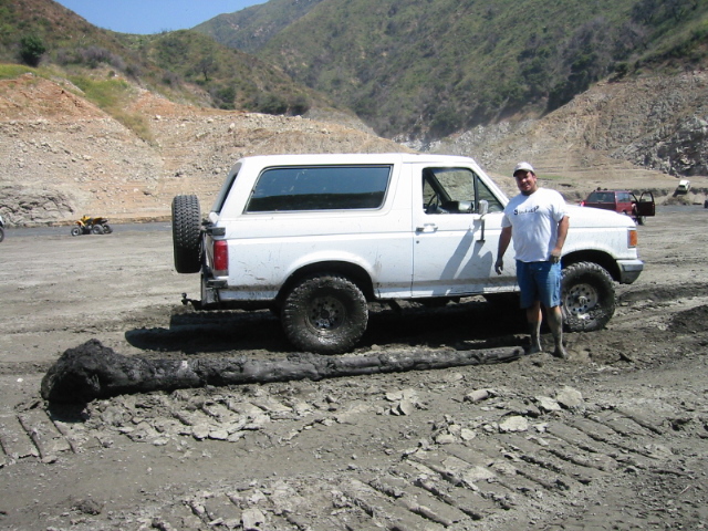After pulling Cam out later we found out the log caused a dent in the tranny pan which caused a minor leak. i'm sorry