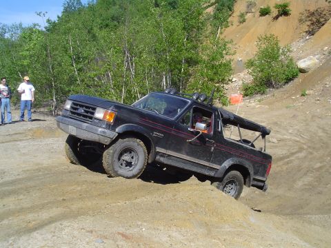 1993 Ford Bronco - Ford Bronco navigates a steep dirt incline during an off-road excursion.