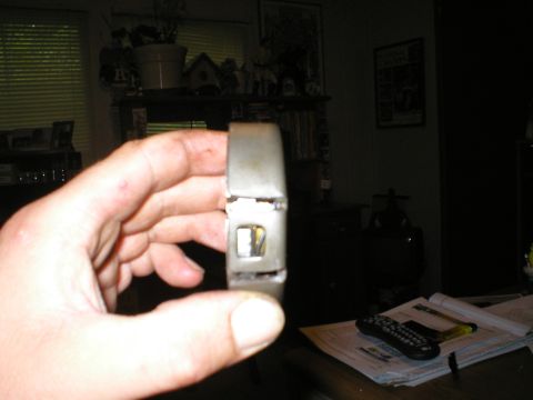 1986 Ford Bronco - Close-up of a metal automotive part being held in a hand.