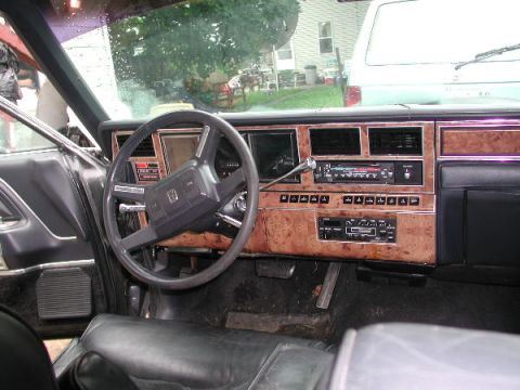1987 Lincoln Town Car - Interior view of a 1987 Lincoln Town Car, wood grain trim on the dashboard and center console.