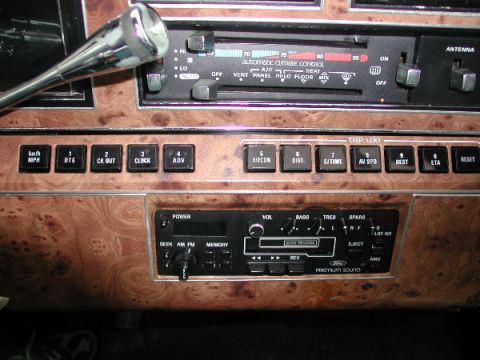 1987 Lincoln Town Car - The interior dashboard of a 1987 Lincoln Town Car features wood grain trim and a premium sound system.