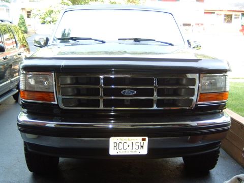 1993 Ford Bronco - Front view of a black Ford Bronco with a chrome grille and a New Jersey license plate.