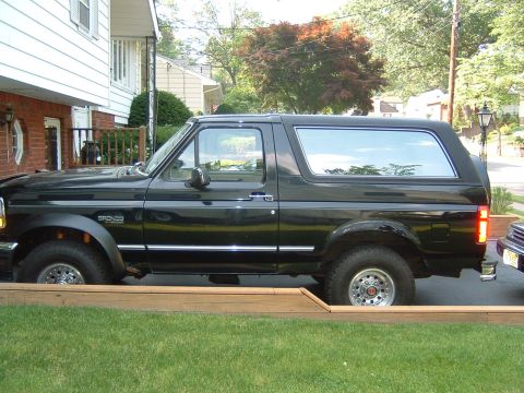 1993 Ford Bronco - Black 1993 Ford Bronco parked in a residential driveway.