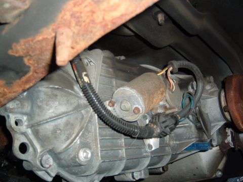 1993 Ford Bronco - Close-up view of a vehicle's transfer case, showing mechanical components and wiring.