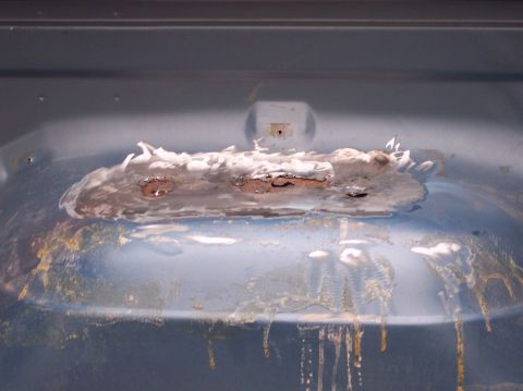 1990 Ford Bronco - Visible rust and body filler on a vehicle's exterior panel, indicating repair needs.