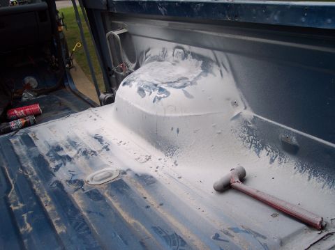 1990 Ford Bronco - Body work in progress on a truck bed, with tools and materials visible.