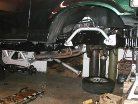 1994 Ford Bronco - Close-up view of the undercarriage and suspension system of a vehicle, with various mechanical components visible.