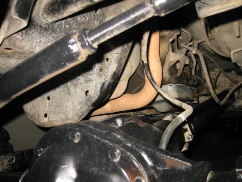 1985 Ford Bronco - A close-up view of the undercarriage reveals the vehicle's suspension and exhaust components.