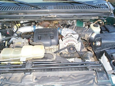 1999 Ford F-250 - Close-up view of the engine compartment of a 1999 Ford F-250, highlighting key components of the diesel engine.