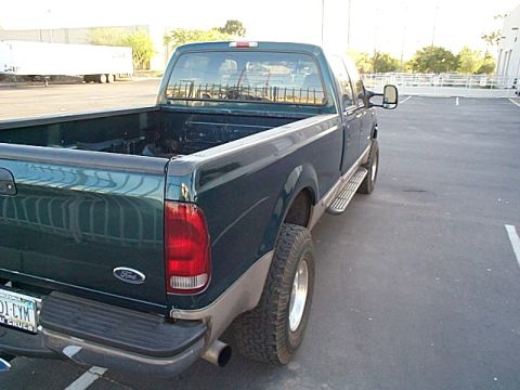 1999 Ford F-250 - This 1999 Ford F-250 pickup truck is seen from the rear passenger side in a parking lot.