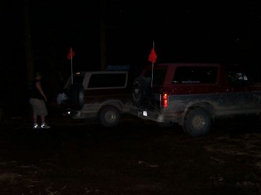 1996 Ford Bronco - Two Ford Broncos are seen parked at night, with orange flags on their antennas.