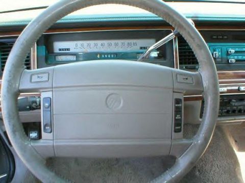 1990 Ford Crown Victoria LTD - Interior view of a 1990 Ford Crown Victoria LTD, focusing on the steering wheel and dashboard instrumentation.