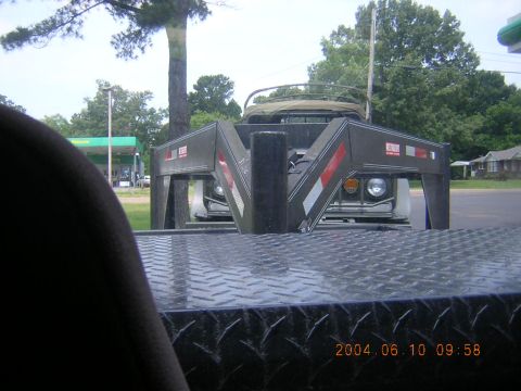 1984 Chevrolet Blazer - A trailer hitch obscures the front of a vintage SUV, possibly from the 1970s, seen at a gas station.
