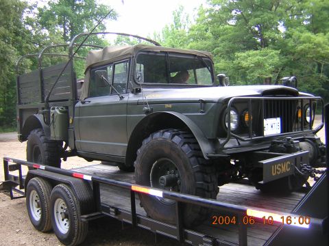1984 Chevrolet Blazer - Olive drab military truck with a soft top and USMC bumper is loaded onto a trailer.