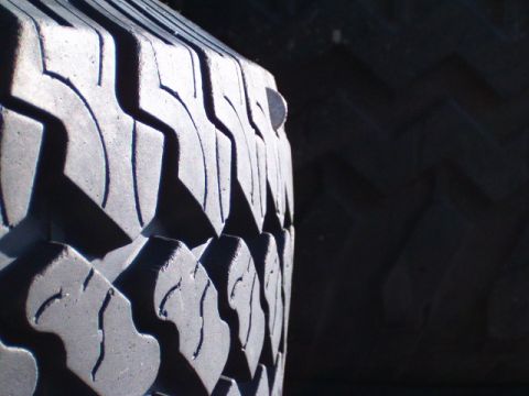 1991 Ford Bronco - A nail is embedded in the tread of a tire, visible in this close-up shot.
