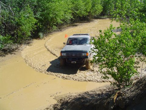 1979 Ford Bronco - This Ford Bronco is tackling a challenging muddy off-road course.
