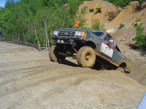 1979 Ford Bronco - This modified Ford F-Series truck navigates a challenging off-road terrain.