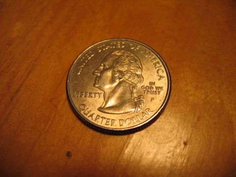 1996 Ford Crown Victoria - A US quarter coin is shown on a wooden surface.