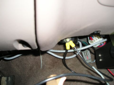 1996 Ford Bronco - This photo shows a close-up view of the wiring harness and connectors located under the dashboard of a vehicle.