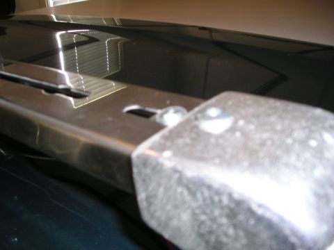 1996 Ford Bronco - A metal roof rack component is visible on the dark-colored vehicle's roof.