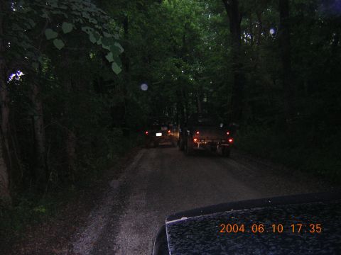 1984 Chevrolet Blazer - Two trucks travel down a wooded dirt road as dusk settles, with a timestamp indicating the photo was taken on June 10, 2004.