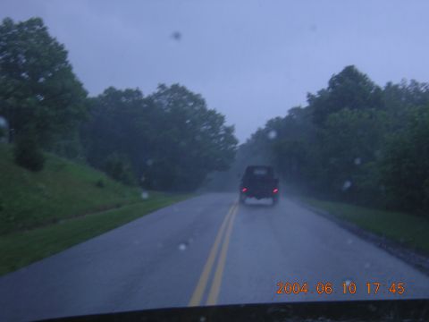 1984 Chevrolet Blazer - A black SUV is seen from behind driving on a wet road during a rain shower.
