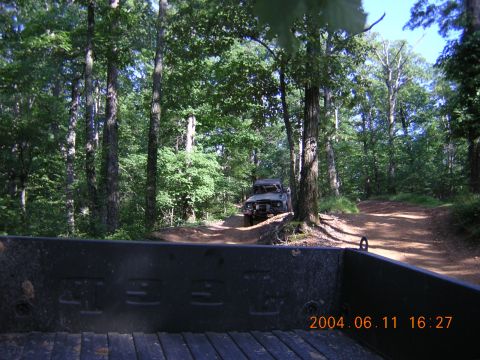 1984 Chevrolet Blazer - Two vehicles navigate a wooded trail on a sunny day. The date stamp indicates the photo was taken on June 11, 2004.