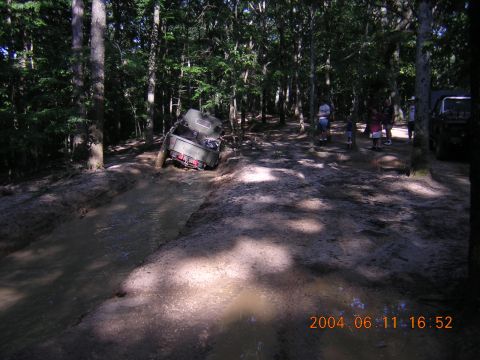 1984 Chevrolet Blazer - A vehicle navigates a muddy trail in a wooded area, with a timestamp indicating the photo was taken in 2004.