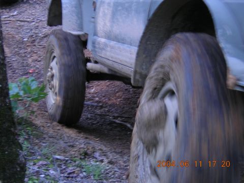 1984 Chevrolet Blazer - Vehicle navigating a muddy trail, tires covered in dirt.