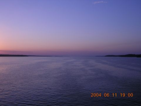 1984 Chevrolet Blazer - A wide shot of a body of water under a twilight sky, with a timestamp and website visible.