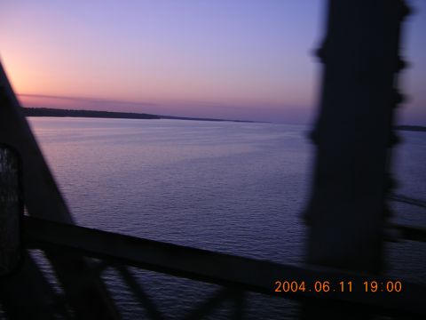 1984 Chevrolet Blazer - A view of a body of water at dusk, with the silhouette of a bridge structure visible in the foreground.