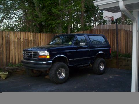 1994 Ford Bronco - This 1994 Ford Bronco features a lifted suspension and large tires, giving it an aggressive stance.
