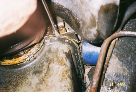 1988 Ford Bronco - This image shows a close-up view of an engine's oil pan and oil filter, with visible grease and grime.