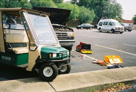 1988 Ford Bronco - Multiple vehicles and tools are present in a parking lot scene.