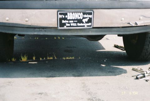 1988 Ford Bronco - The rear of a vehicle shows a license plate frame with text and an image of a horse.