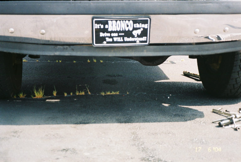 Rear bumper of a Bronco with a plate frame that says 'It's a BRONCO thing. Drive one -- You WILL Understand!!'