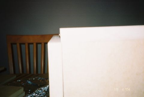 1988 Ford Bronco - A view of a room's interior, showing a chair and a large white object. A Supermotors logo is visible.