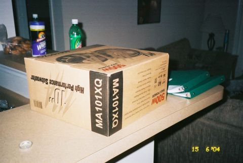1988 Ford Bronco - A box for a 10-inch high-performance subwoofer is displayed on a counter, with cleaning supplies and a beverage in the background.