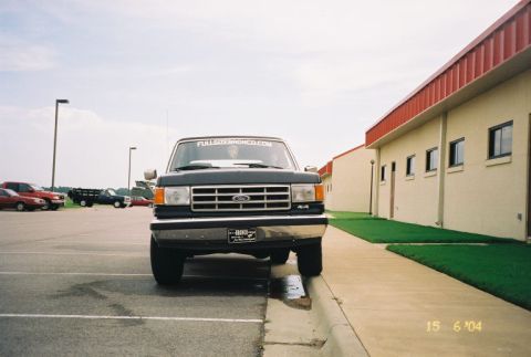 1988 Ford Bronco - Ford F-Series truck from the 1987-1991 generation is parked on a curb in front of a building.