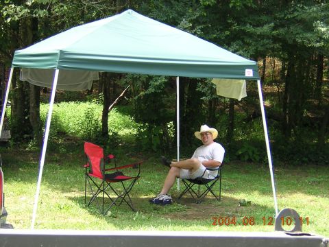 1984 Chevrolet Blazer - A man relaxes in a camping chair under a canopy, with laundry hanging nearby.