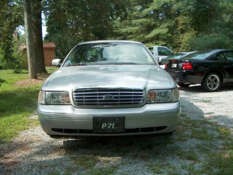 2000 Ford Crown Victoria - Front view of a silver 2000 Ford Crown Victoria, identified by its P71 license plate, parked outdoors.