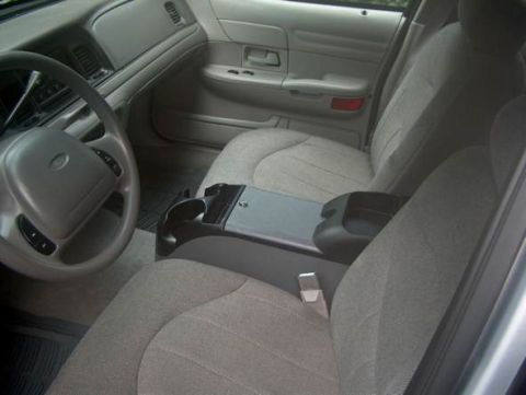 2000 Ford Crown Victoria - The interior of a 2000 Ford Crown Victoria is visible, including the dashboard, steering wheel, and seats.