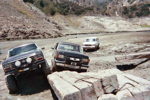 Lifted SUVs gathered on a dirt trail with light bar and bumper guards